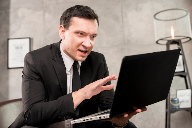 Excited young businessman explaining and gesturing 