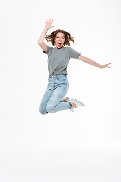 Excited young caucasian lady jumping