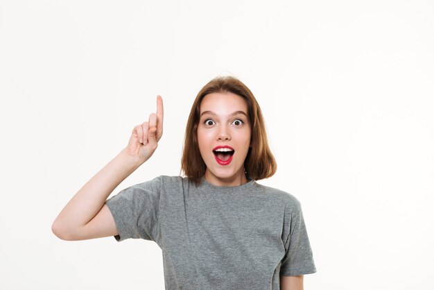 Excited young caucasian lady pointing.