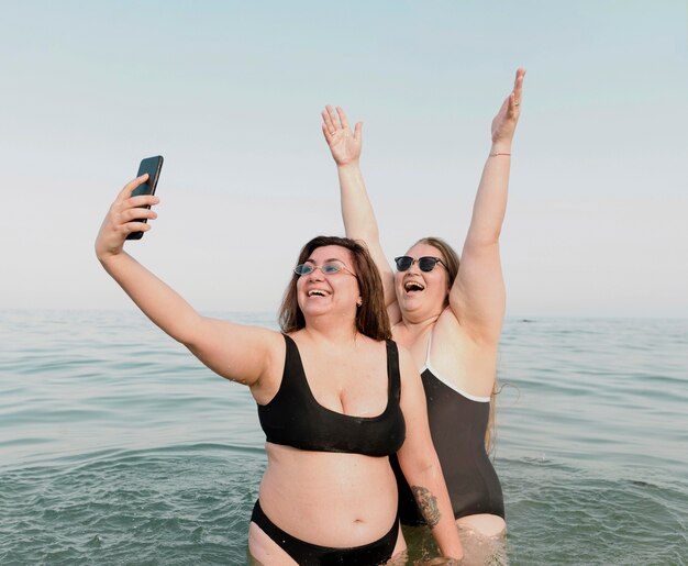 Excited young friends taking a self photo