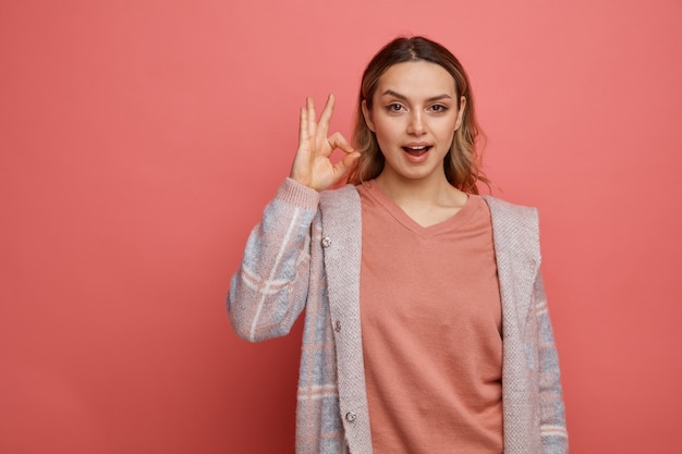 Excited young girl doing ok sign 
