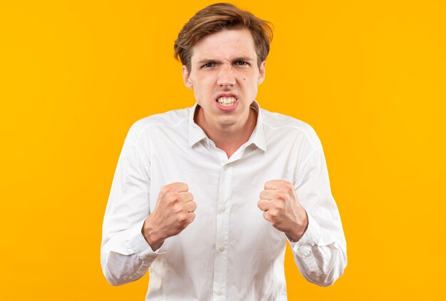 Excited young handsome guy wearing white shirt showing yes gesture 