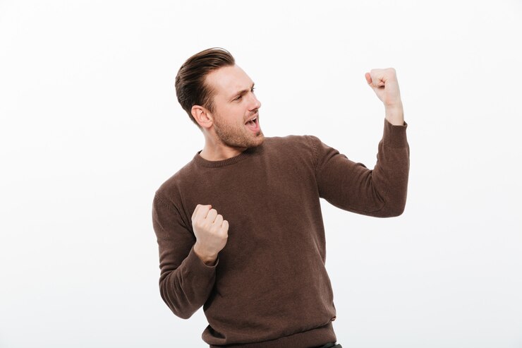 Free Photo excited young man make winner gesture.