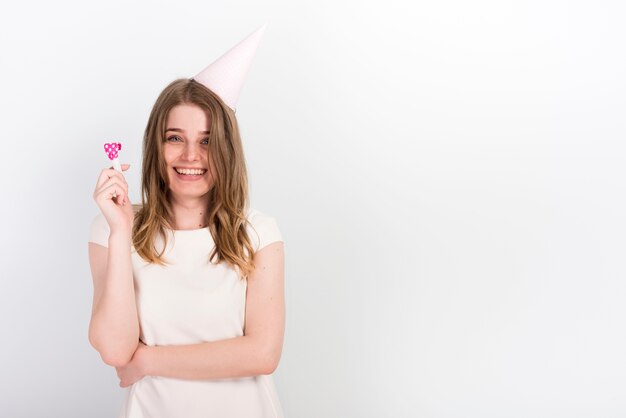 Excited young woman in party hat having fun