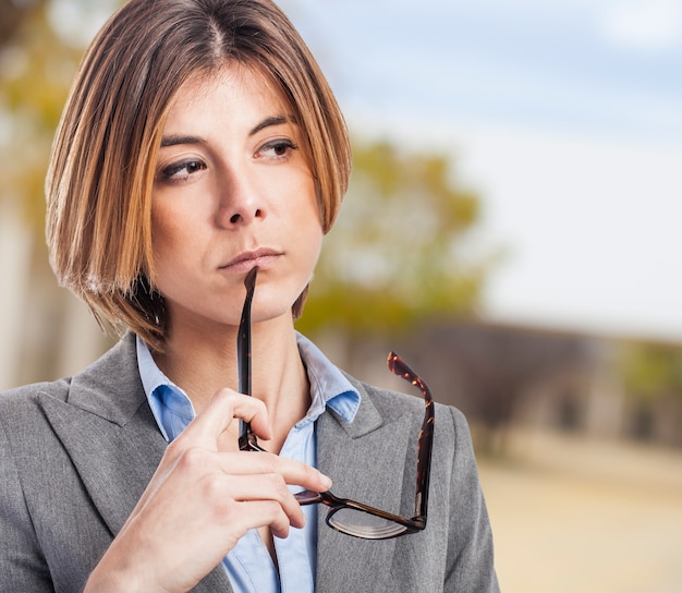 Executive thinking with glasses in the hand