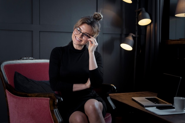 Executive young woman with eyeglasses posing