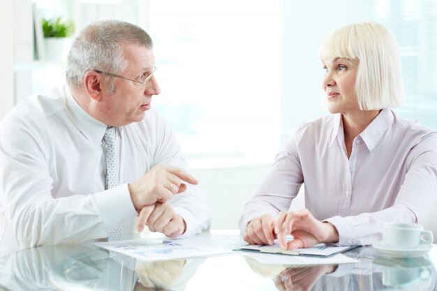 Executives pointing a business document