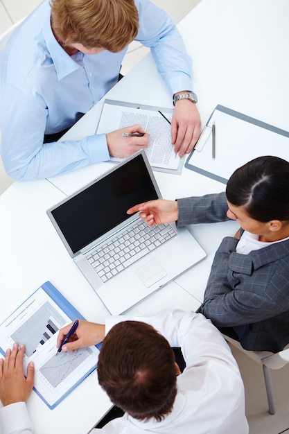 Executives working together on a laptop