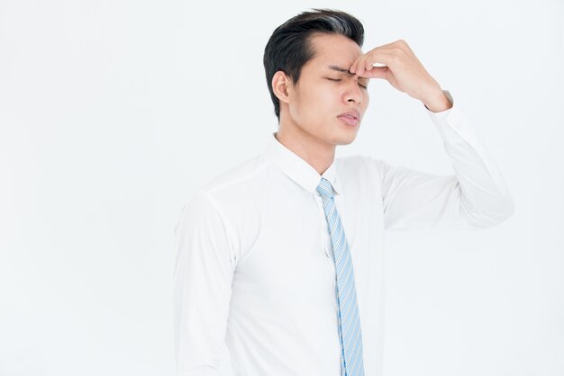 Exhausted Asian businessman feeling pain