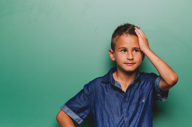 Free photo exhausted boy at blackboard