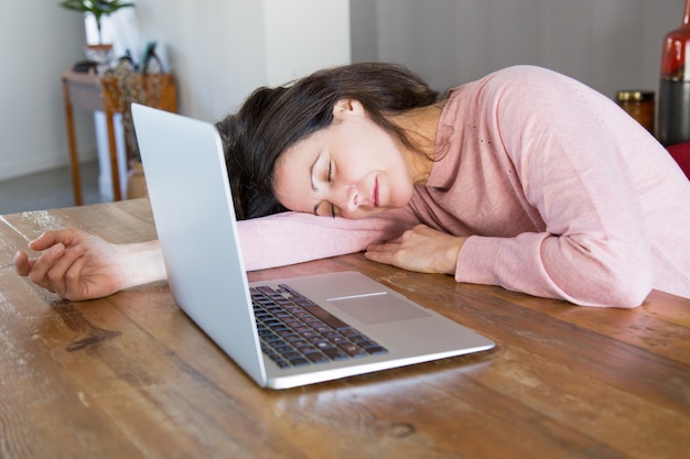 Exhausted freelance worker sleeping at workplace