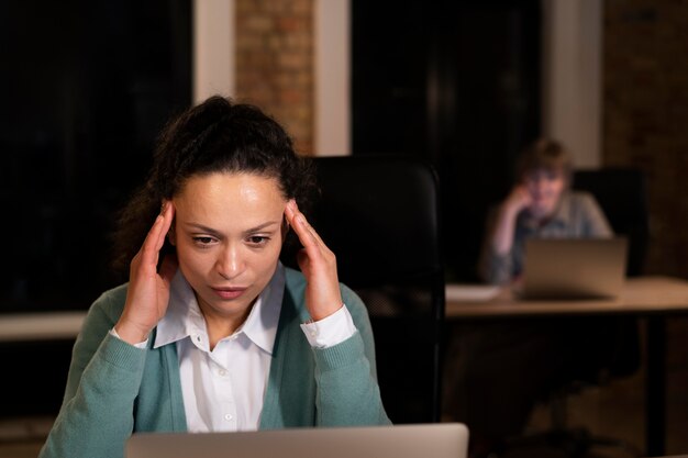 Exhausted people at the office working late