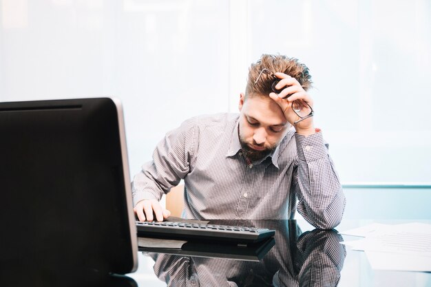 Exhausted sleep man in office