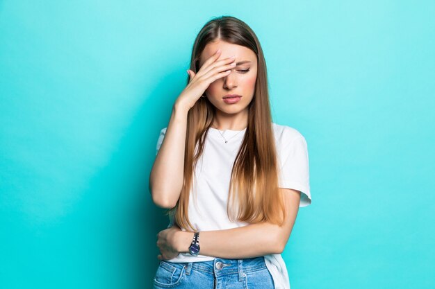 Exhausted woman touching head while standing with closed eyes