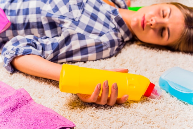 Exhausted young woman after cleaning the house