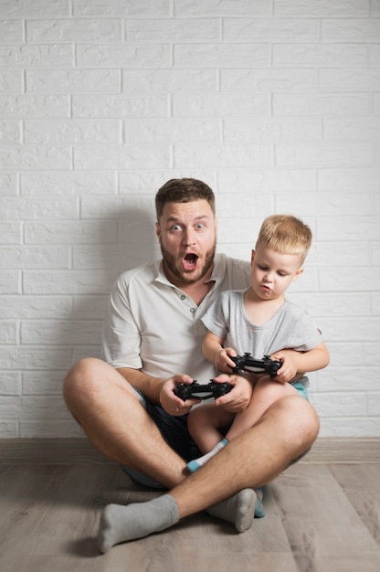 Exited father and son playing games at home