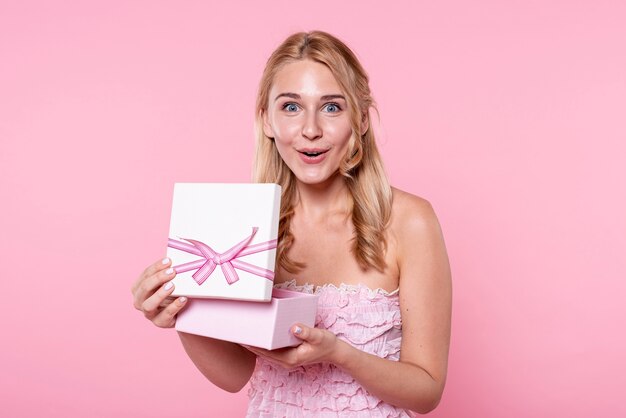 Exited woman opening gifts at party