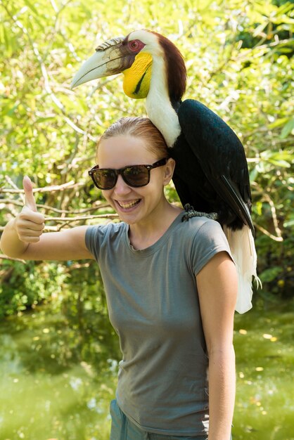 Exotic bird on a womans shoulder