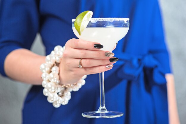 The exotic cocktail and female hands