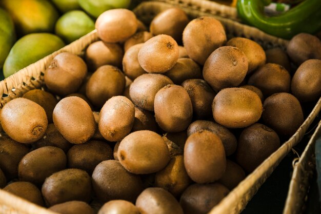 Exotic delicious organic kiwi in wicker basket at market