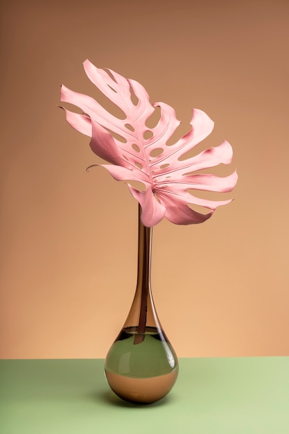 Free photo exotic pink leaf in vase still life