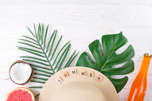 Free photo exotic vacation arrangement of fruit and beach hat