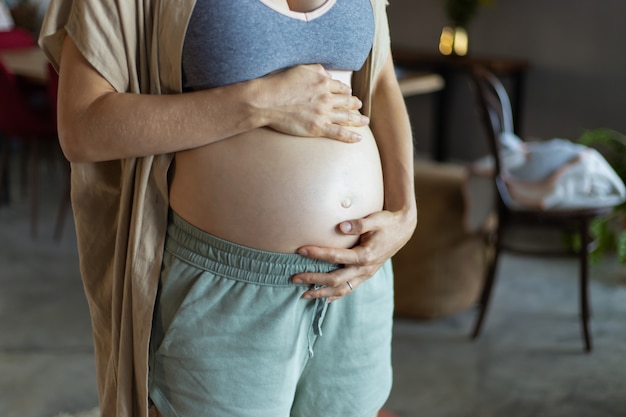 Expectant mother wearing bra and pants