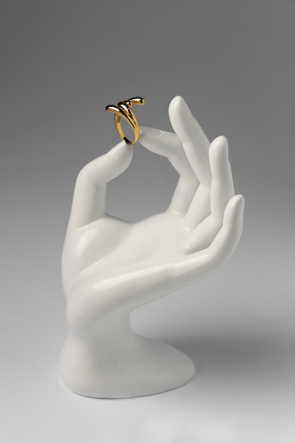 Expensive golden ring with human hand stand display