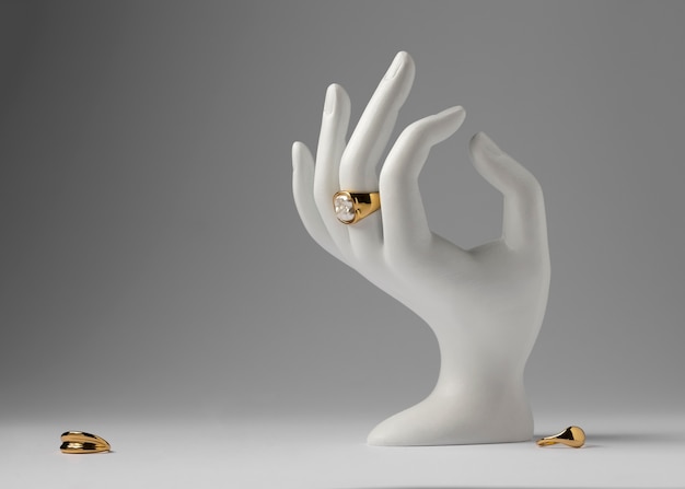 Expensive golden ring with human hand stand display