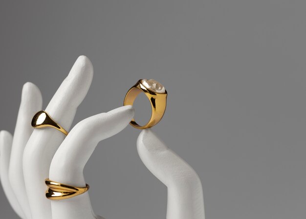 Expensive golden ring with human hand stand display