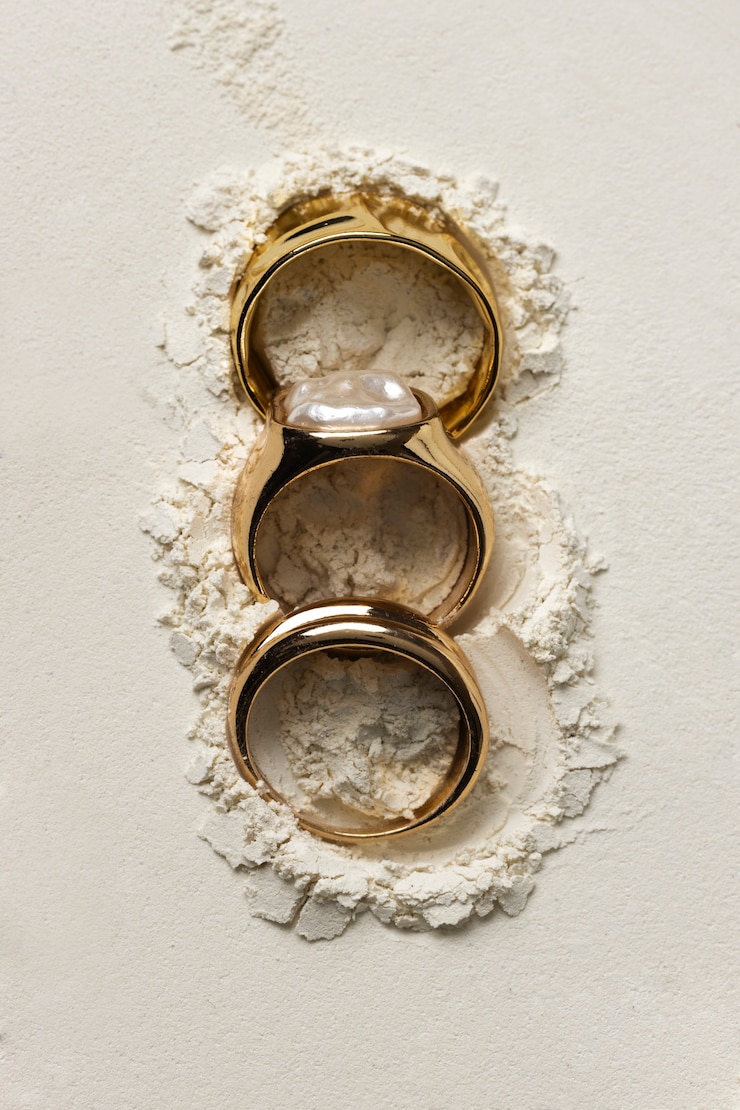 Free Photo expensive golden ring with white powder background