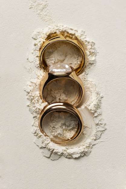 Expensive golden ring with white powder background