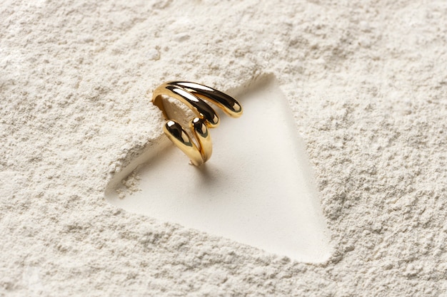 Expensive golden ring with white powder background