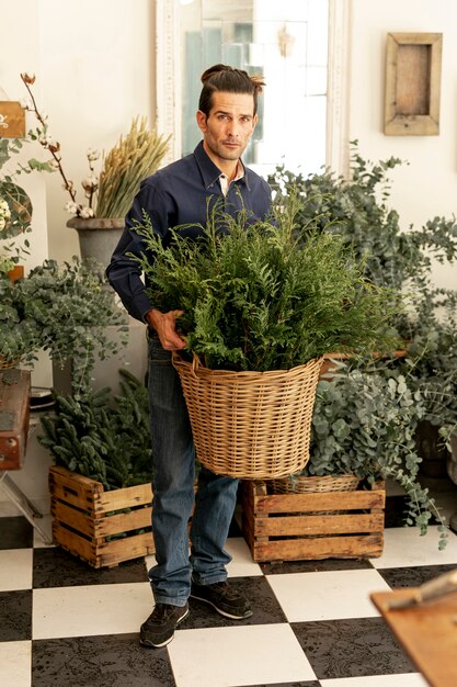 Experienced florist holding basket of plants