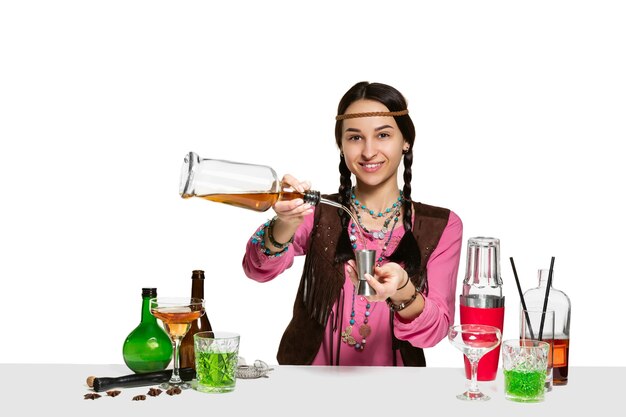 Expert female barman is making cocktail at isolated on white background.