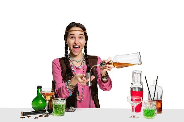 Expert female barman is making cocktail at studio isolated on white background. International barman day, bar, alcohol, restaurant, party, pub, nightlife, cocktail, nightclub concept