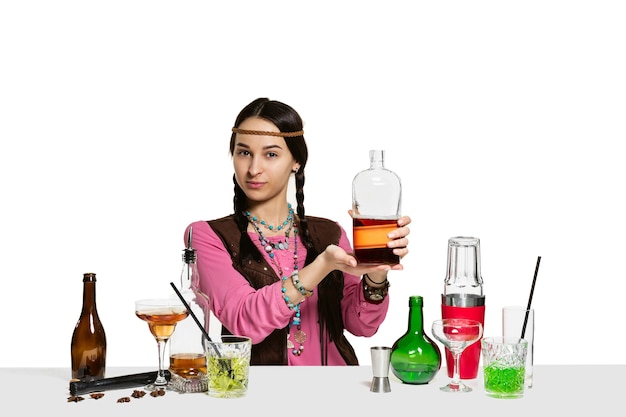 Free photo expert female barman is making cocktail at studio isolated on white wall