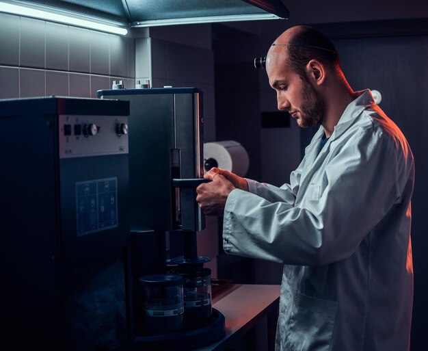 Expirienced watchmaker is working with autoclave at his own studio.