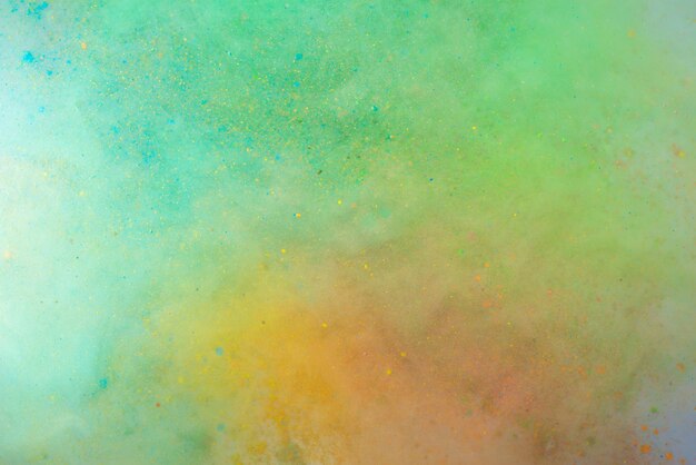 Explosion of colored powder on white background