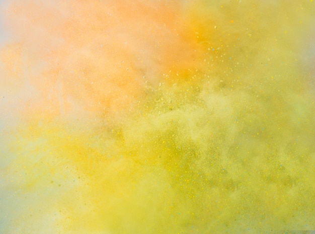 Explosion of colored powder on white background