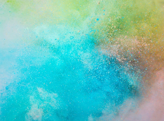 Explosion of colored powder on white background