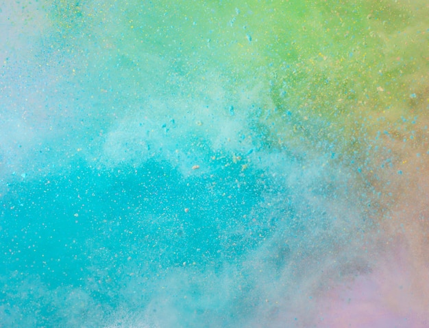 Explosion of colored powder on white background