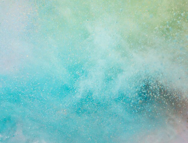 Explosion of colored powder on white background