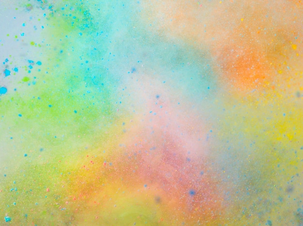 Explosion of colored powder on white background