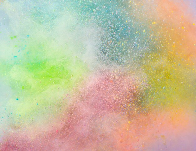 Explosion of colored powder on white background