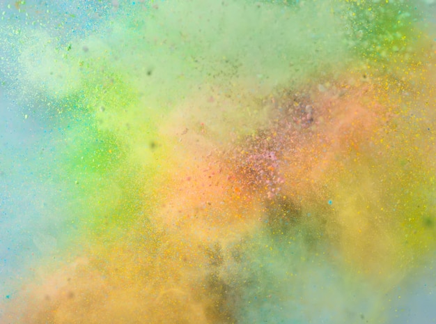 Explosion of colored powder on white background