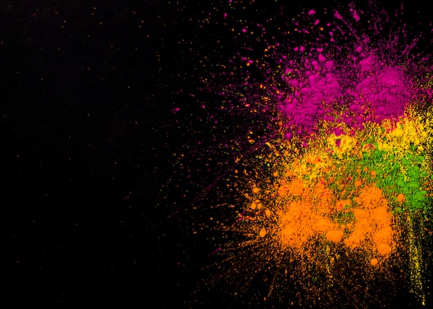 Free photo explosion of holi colors on dark background