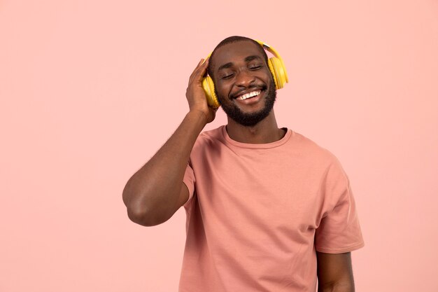 Expressive african american man listening to music on headphones