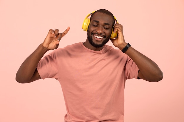 Expressive african american man listening to music on headphones