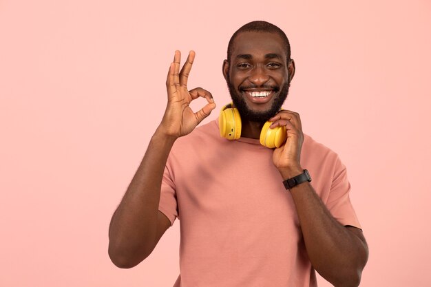 Expressive african american man listening to music on headphones